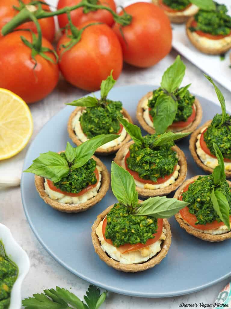 plate with tomato tartlets with lemon, pesto, and tomatoes