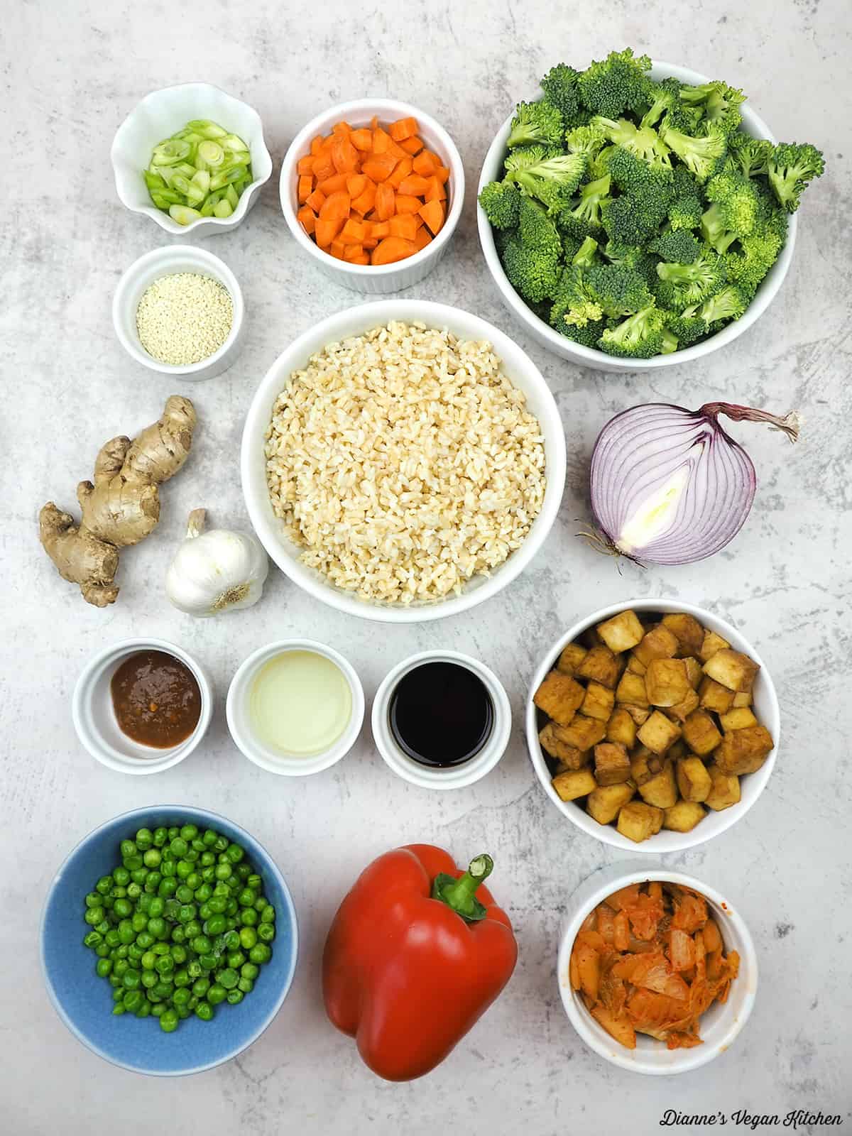 Scallion, carrot, broccoli, rice, vinegar, garlic, ginger, onion, tofu, kimchi, bell pepper, green peas, garlic chili paste, tamari, sesame seeds