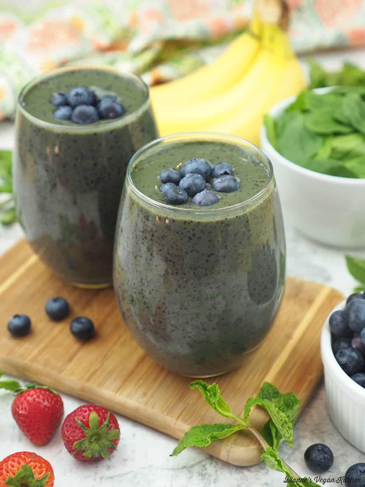 Blueberry Smoothie with blueberries, bananas, strawberries and a bowl of spinach