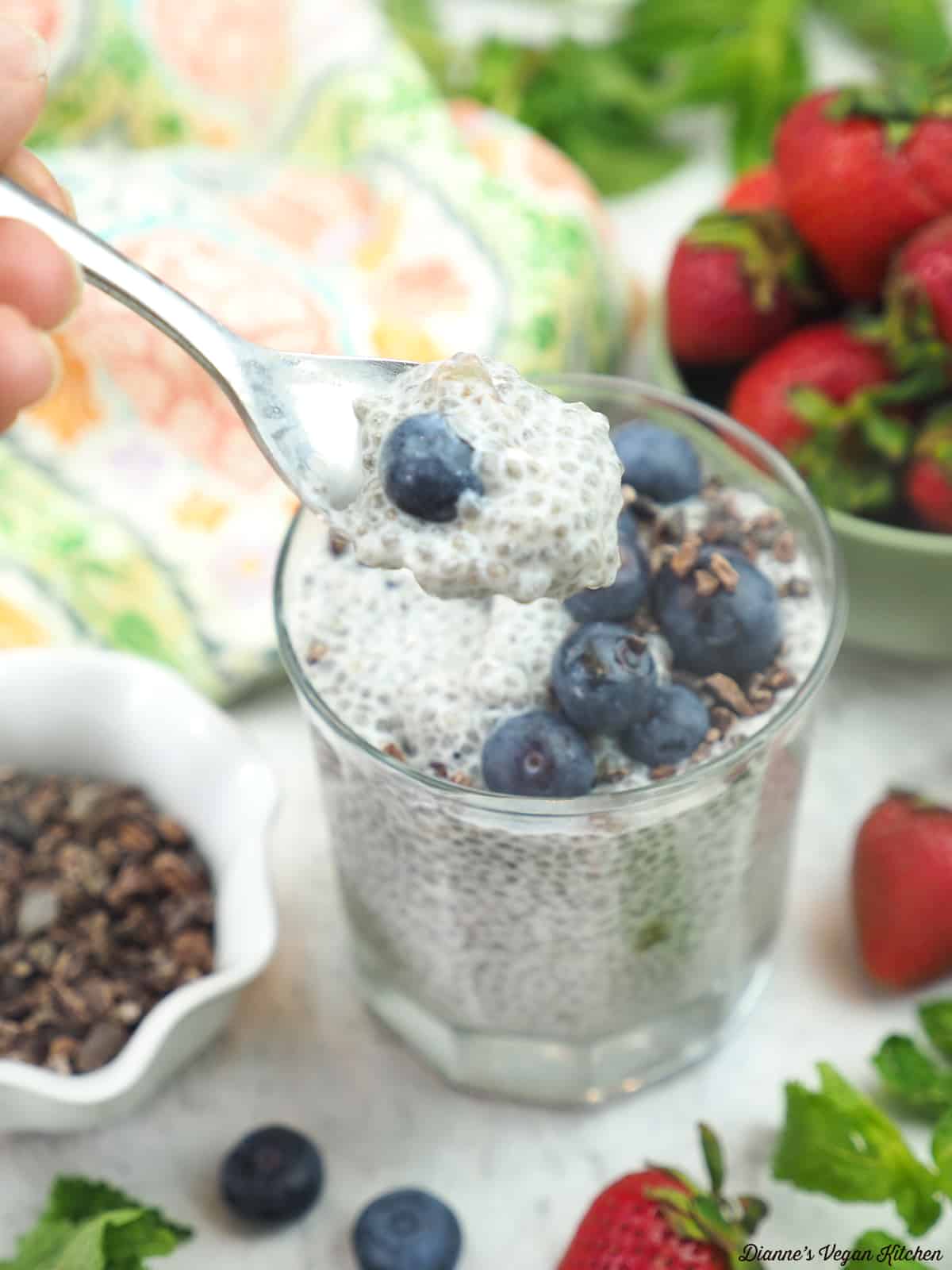 spooning chia pudding out of a glass
