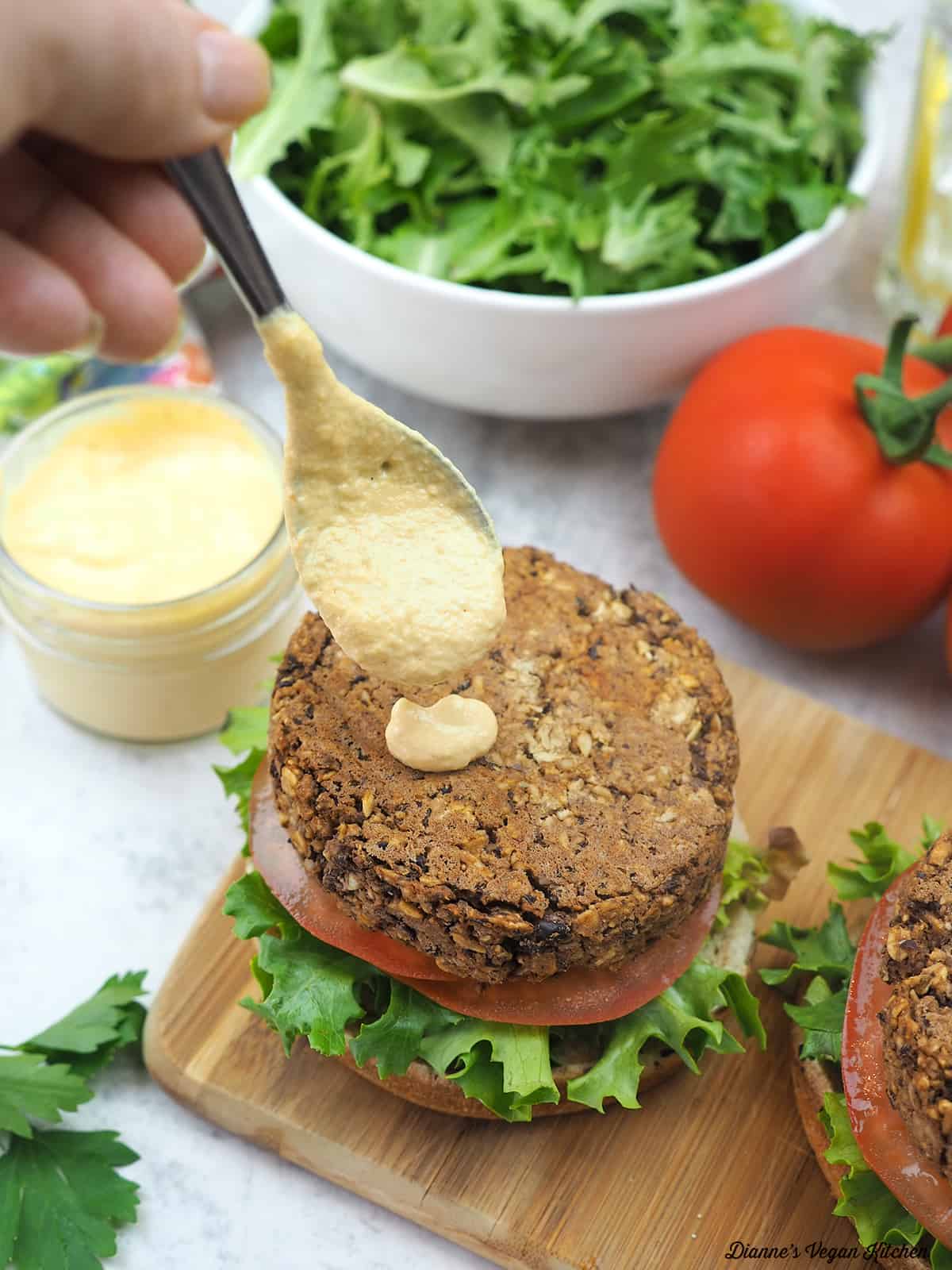 dripping cashew cheese onto a burger