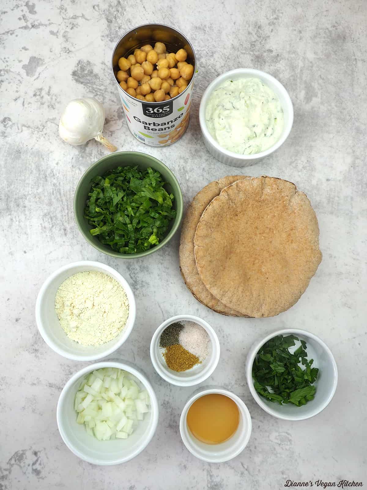 garlic, chickpeas, sauce, lettuce, pitas, spices, parsley, onions, vegetable stock, and chickpea flour