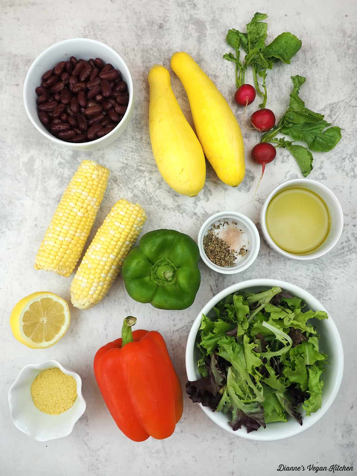 kidney beans, summer squash, radishes, corn on the cob, bell peppers, spices, nutritional yeast, lemon, olive oil, greens