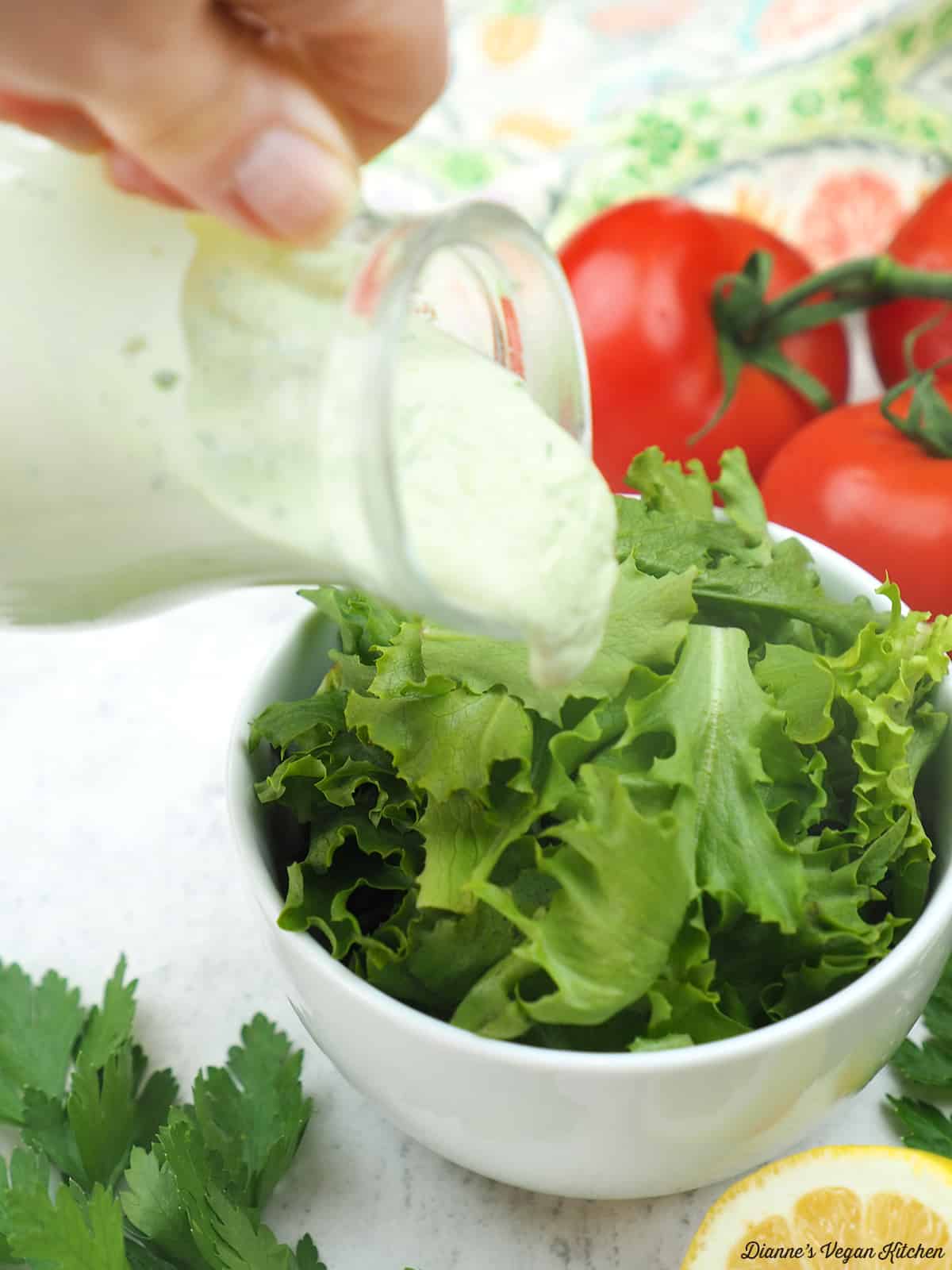 pouring dressing on a salad